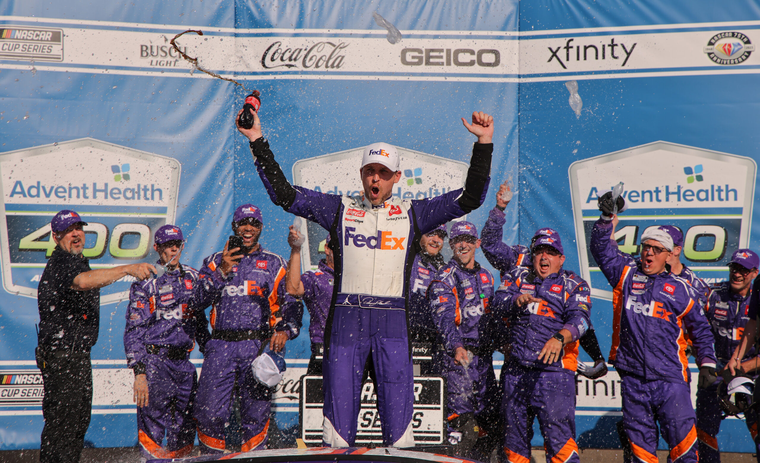 Denny Hamlin, driver of the #11 FedEx Express Toyota, celebrates in victory lane after winning the NASCAR Cup Series Advent Health 400 at Kansas Speedway on May 07, 2023 in Kansas City, Kansas.